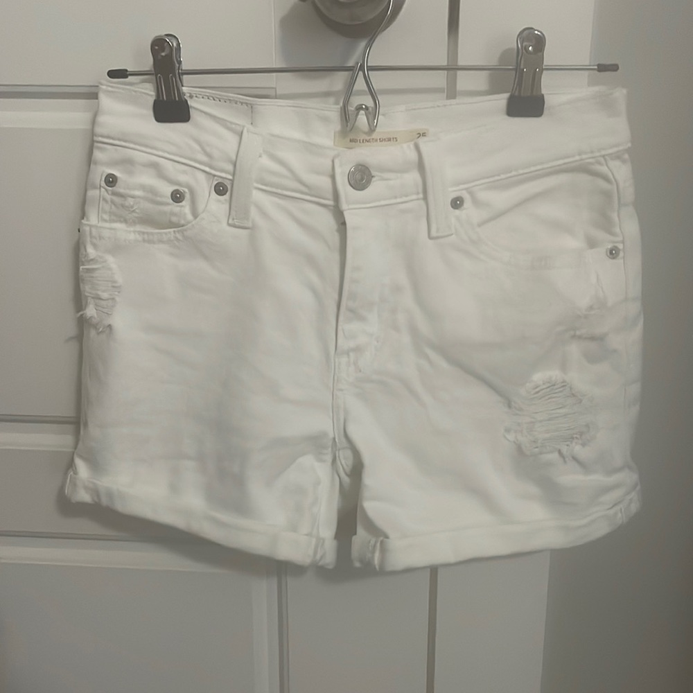 White Levi mid length distressed jean shorts
